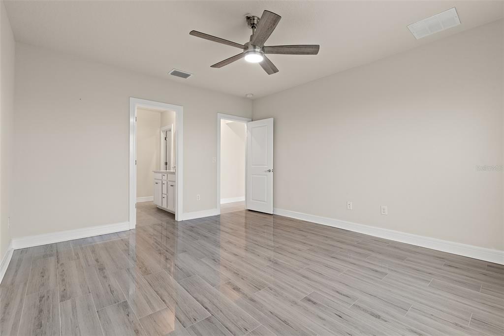 9256 Royal River Circle Parrish, FL 34219 - Photo 15 of 38 an empty room with wooden floor and ceiling fan