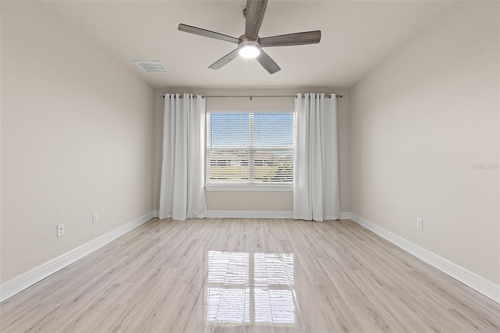 9256 Royal River Circle Parrish, FL 34219 - Photo 16 of 38 wooden floor in an empty room with a window