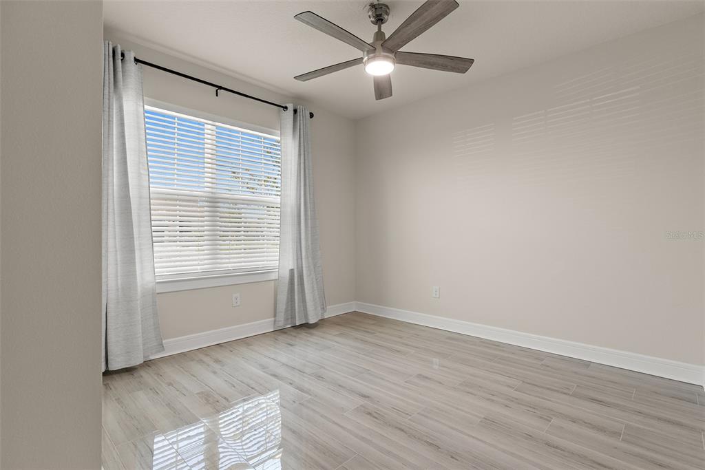 9256 Royal River Circle Parrish, FL 34219 - Photo 17 of 38 a view of empty room with wooden floor and fan