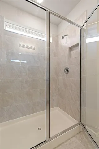 a bathroom with a glass shower door