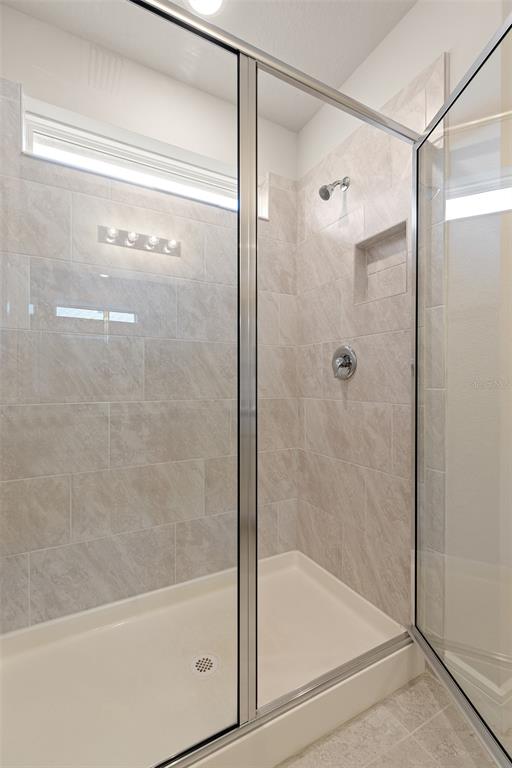 9256 Royal River Circle Parrish, FL 34219 - Photo 19 of 38 a bathroom with a glass shower door