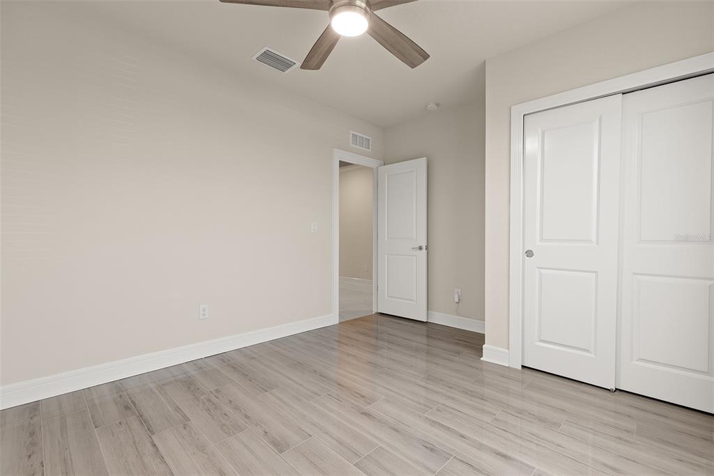 9256 Royal River Circle Parrish, FL 34219 - Photo 21 of 38 a view of an empty room with wooden floor