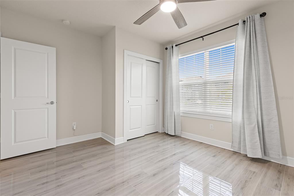 9256 Royal River Circle Parrish, FL 34219 - Photo 22 of 38 a view of an empty room with wooden floor and a window