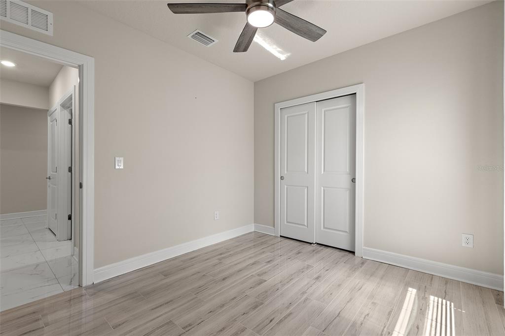 9256 Royal River Circle Parrish, FL 34219 - Photo 25 of 38 wooden floor in an empty room with a window