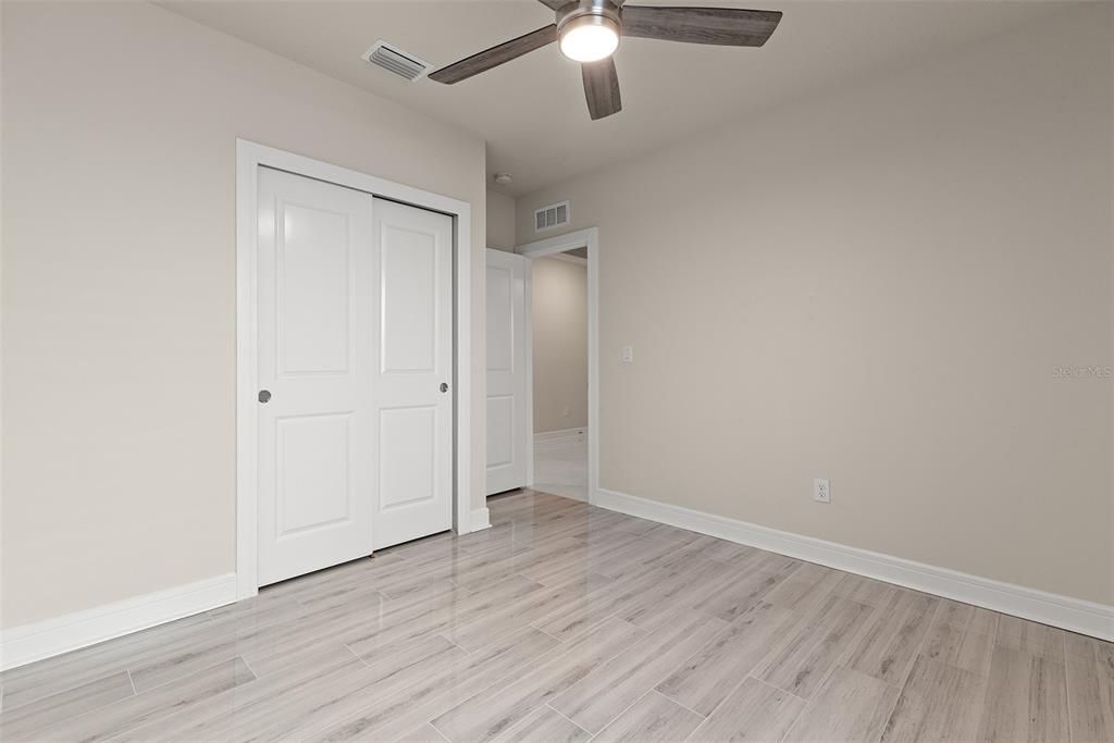9256 Royal River Circle Parrish, FL 34219 - Photo 28 of 38 an empty room with wooden floor fan and window