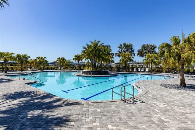 a view of swimming pool with outdoor seating and yard in back