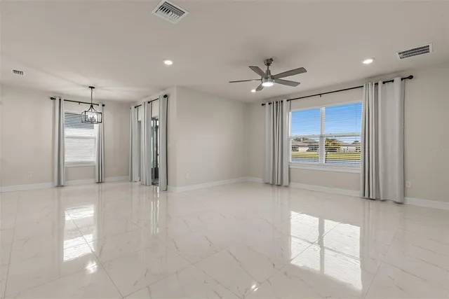 a view of an empty room with a kitchen