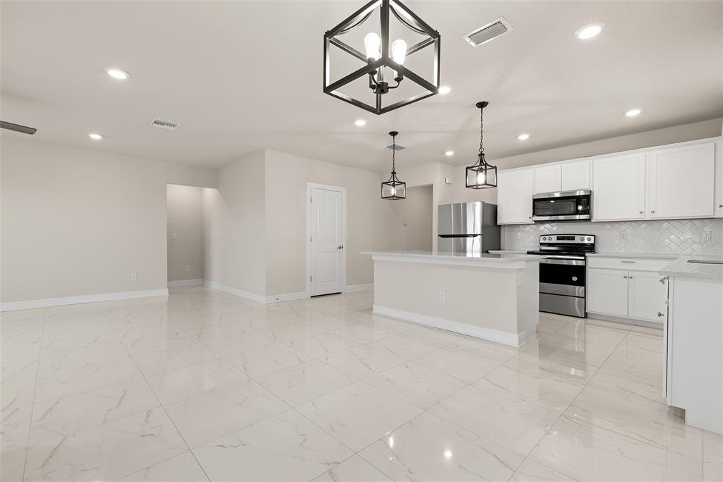 9256 Royal River Circle Parrish, FL 34219 - Photo 8 of 38 a view of kitchen with microwave and cabinets
