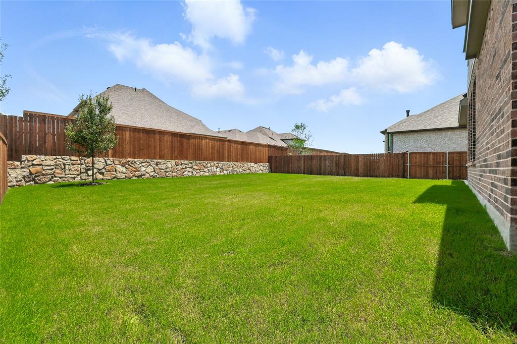 509 Hummingbird Lane Van Alstyne, TX 75495 - Photo 27 of 40 a view of a garden with a building in the background