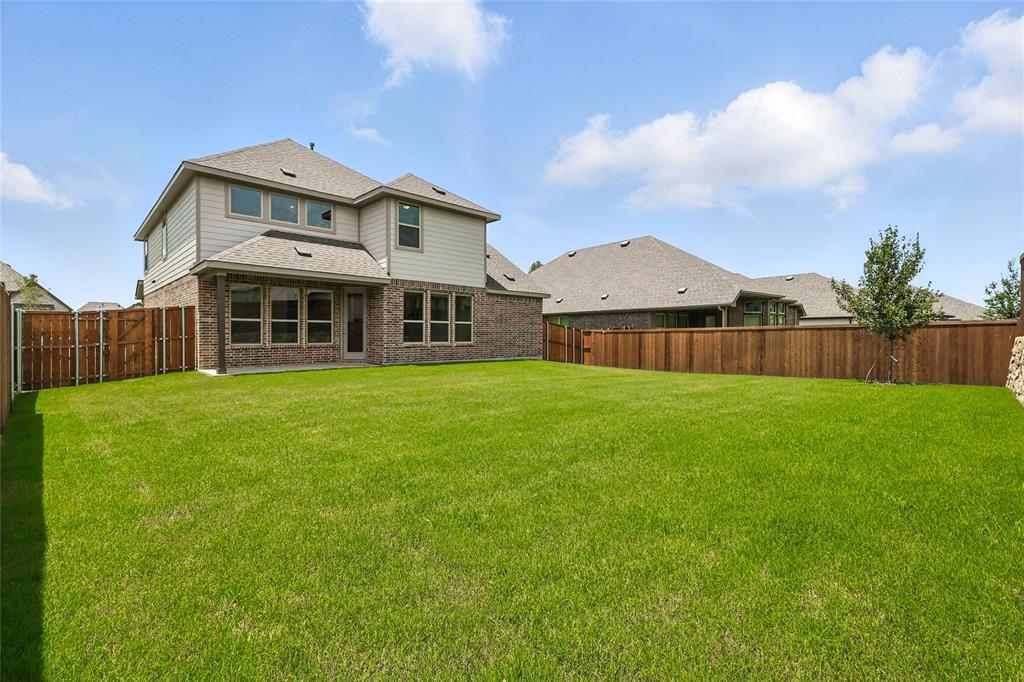 509 Hummingbird Lane Van Alstyne, TX 75495 - Photo 28 of 40 a front view of a house with garden