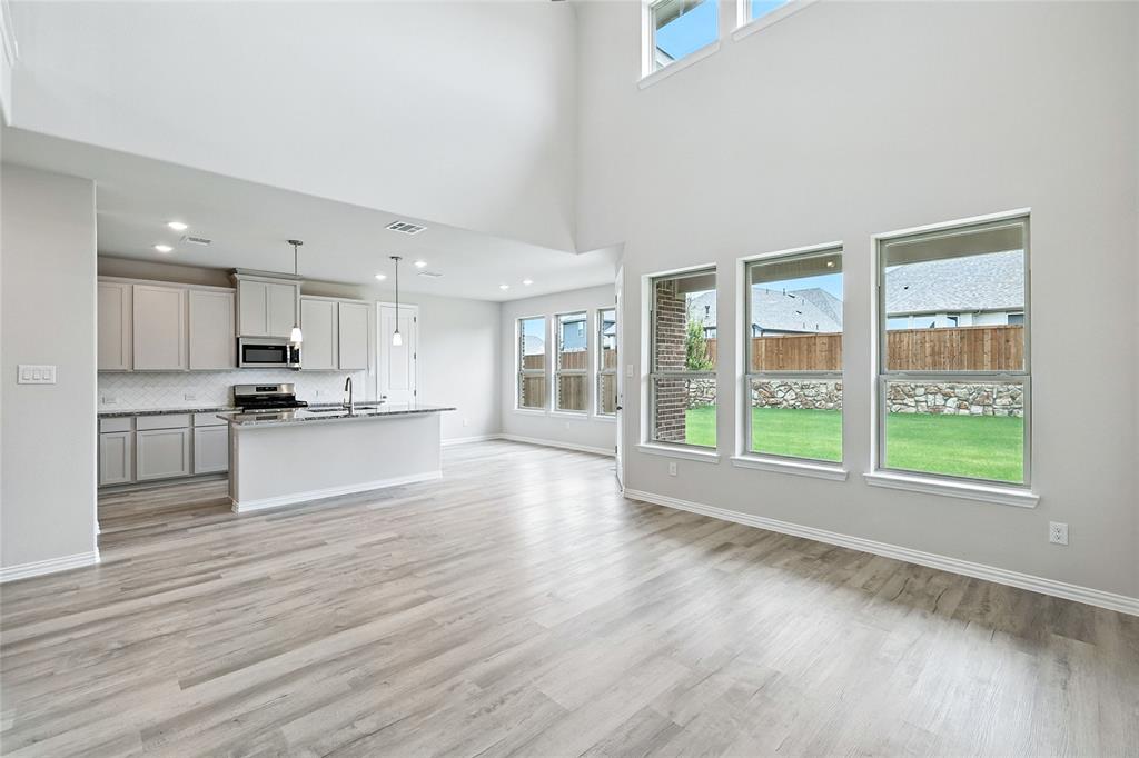 509 Hummingbird Lane Van Alstyne, TX 75495 - Photo 8 of 40 a view of large kitchen with large windows and wooden floor