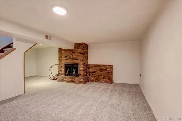 an empty room with furniture and a fireplace