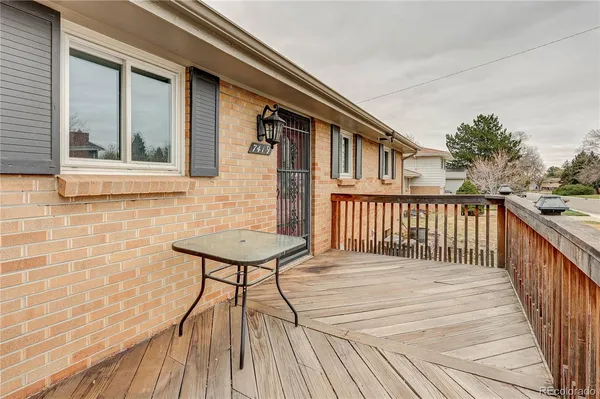 a balcony view with a wooden floor and fence