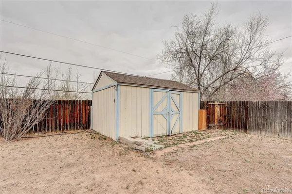 a big house with a big yard and large trees