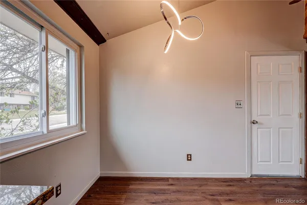 a view of a room with wooden floor and windows