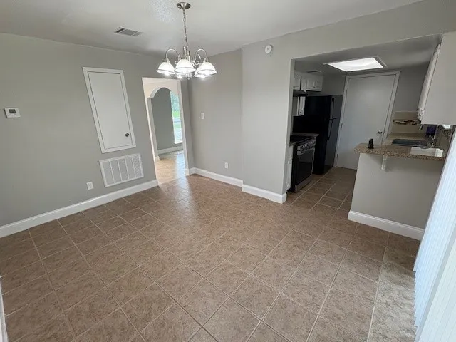 a kitchen with a sink stove and refrigerator