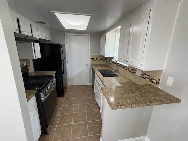 a kitchen with a stove and a refrigerator