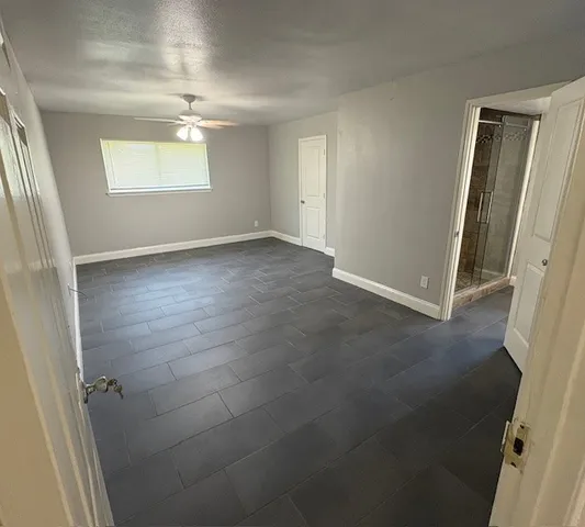 a bathroom with a granite countertop toilet sink and mirror