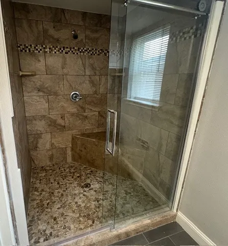 en empty room with wooden floor and fan