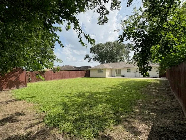 a white house sitting in middle of the forest