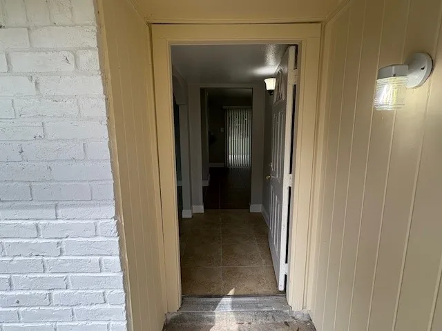 a view of a hallway with a bathroom