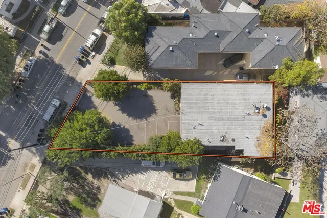 an aerial view of a house with a yard