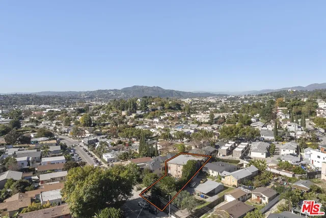 an aerial view of residential houses with city view