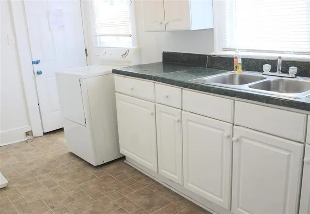 a kitchen with a sink and cabinets