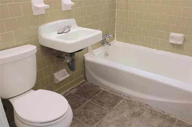 a bathroom with a sink a toilet and bathtub