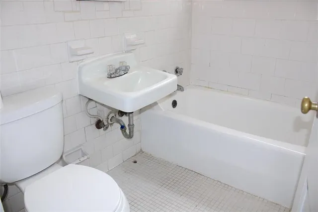 a bathroom with a sink a toilet and bathtub