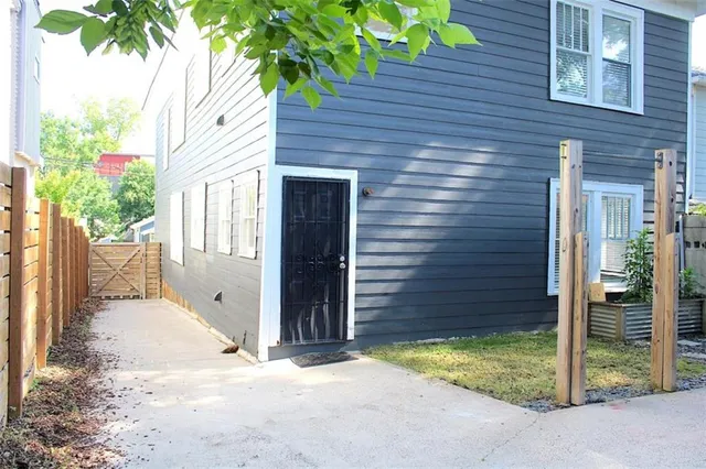 a view of backyard of house and tree