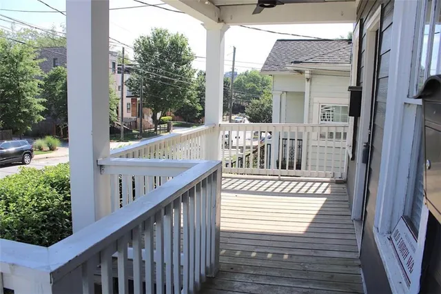 a view of a balcony with wooden floor