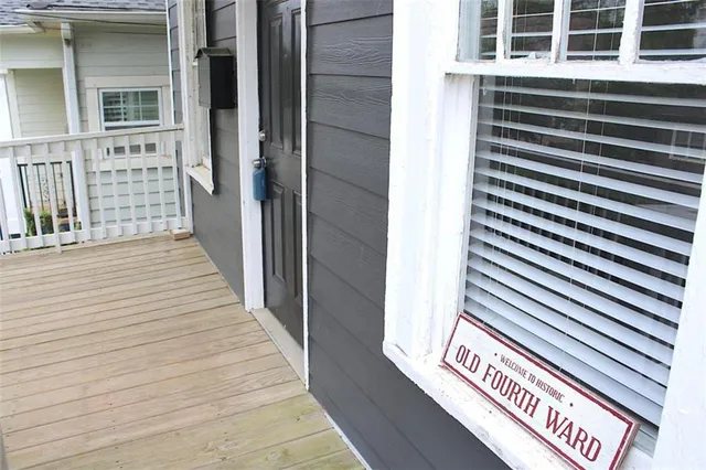 a view of a street with wooden fence