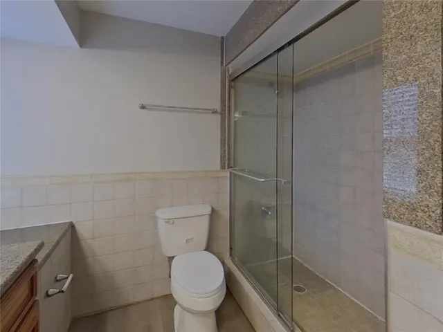a bathroom with a toilet and a shower