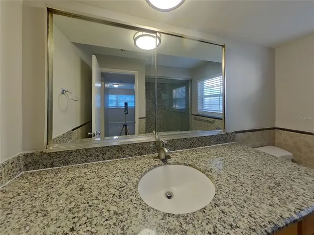 a bathroom with a sink and a mirror