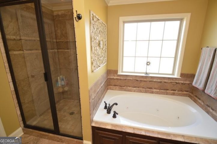 300 Grand Reserve Way Kathleen, GA 31047 - Photo 13 of 24 a bathroom with a bathtub and a shower