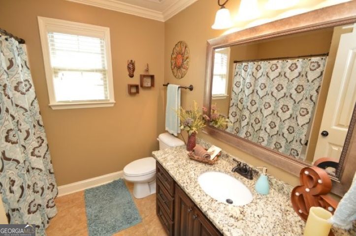 300 Grand Reserve Way Kathleen, GA 31047 - Photo 18 of 24 a bathroom with a granite countertop sink and a mirror