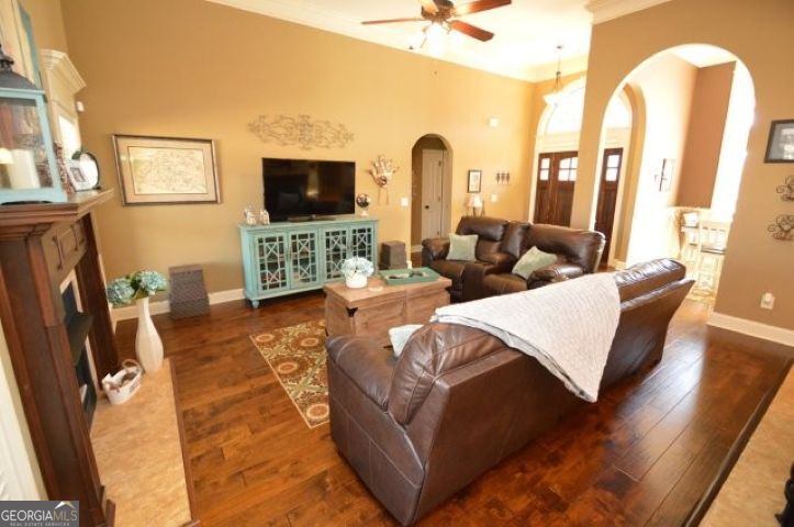 300 Grand Reserve Way Kathleen, GA 31047 - Photo 3 of 24 a living room with furniture a flat screen tv and a fireplace