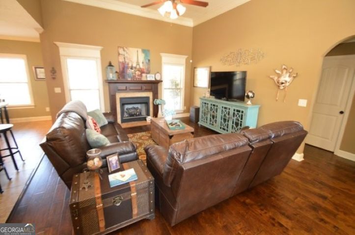 300 Grand Reserve Way Kathleen, GA 31047 - Photo 4 of 24 a living room with furniture a flat screen tv and a fireplace