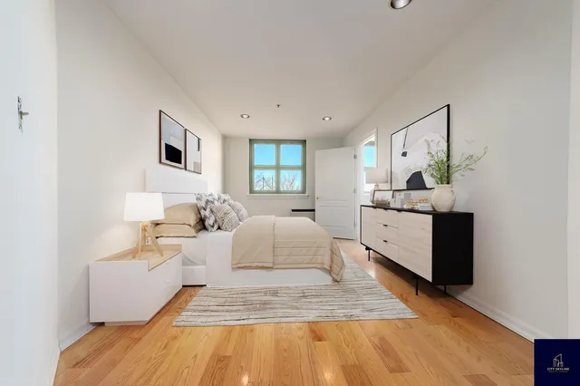 a spacious bedroom with a bed a couch and cabinet