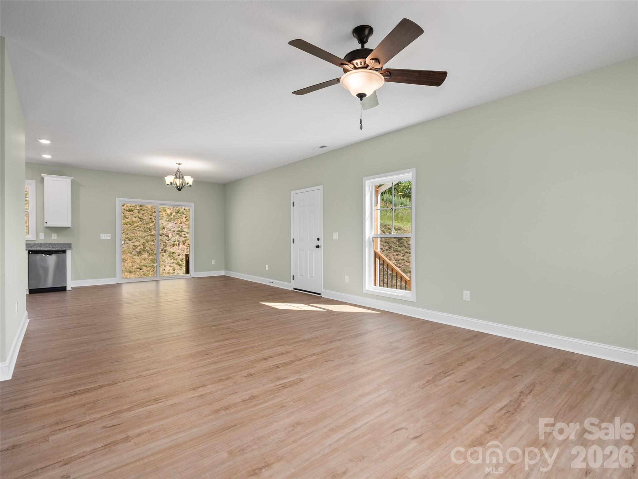 373 Barefoot Ridge Clyde, NC 28721 - Photo 11 of 30 a view of an empty room with a window and wooden floor