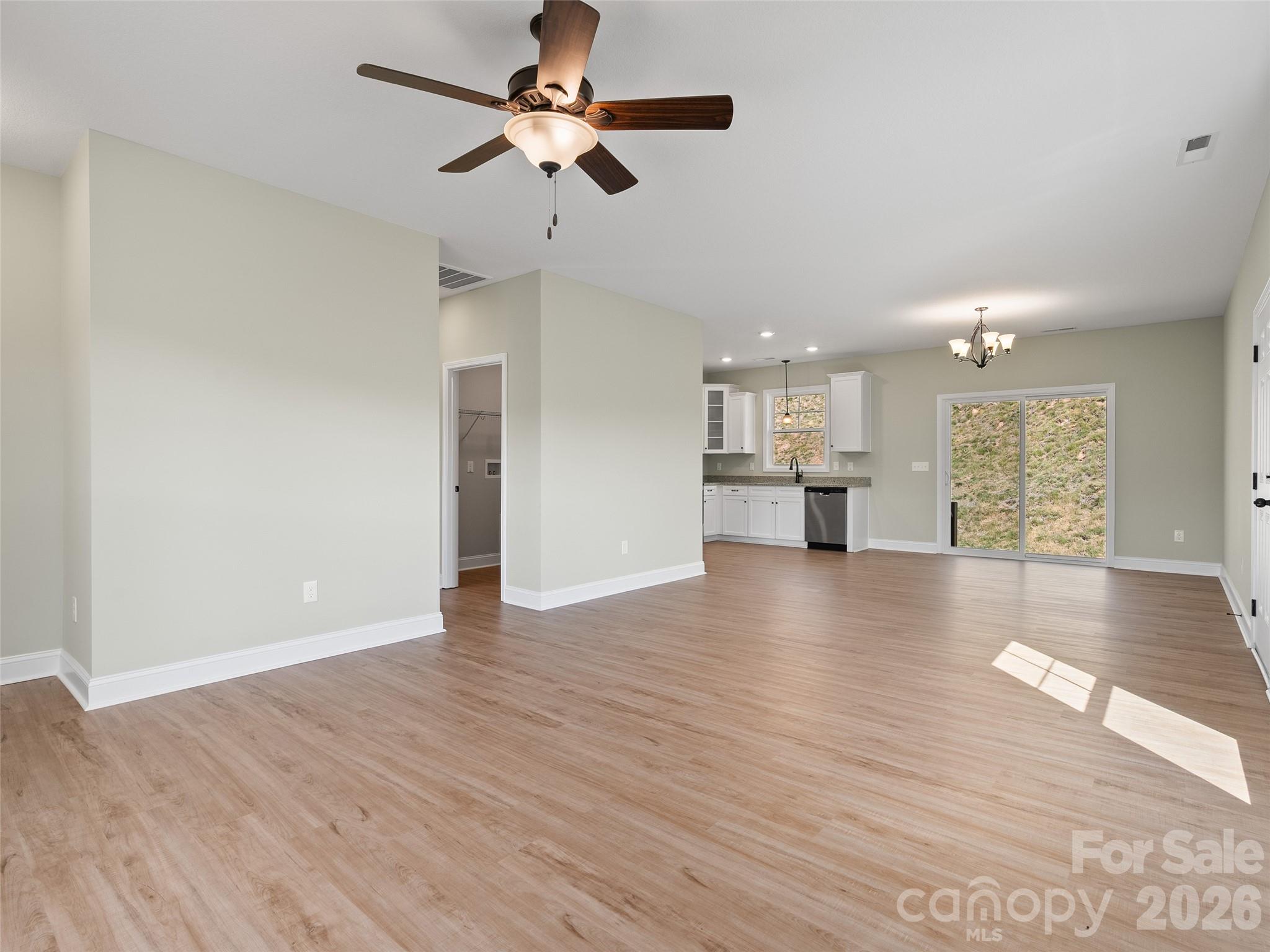 373 Barefoot Ridge Clyde, NC 28721 - Photo 12 of 30 a view of an empty room with wooden floor and a window
