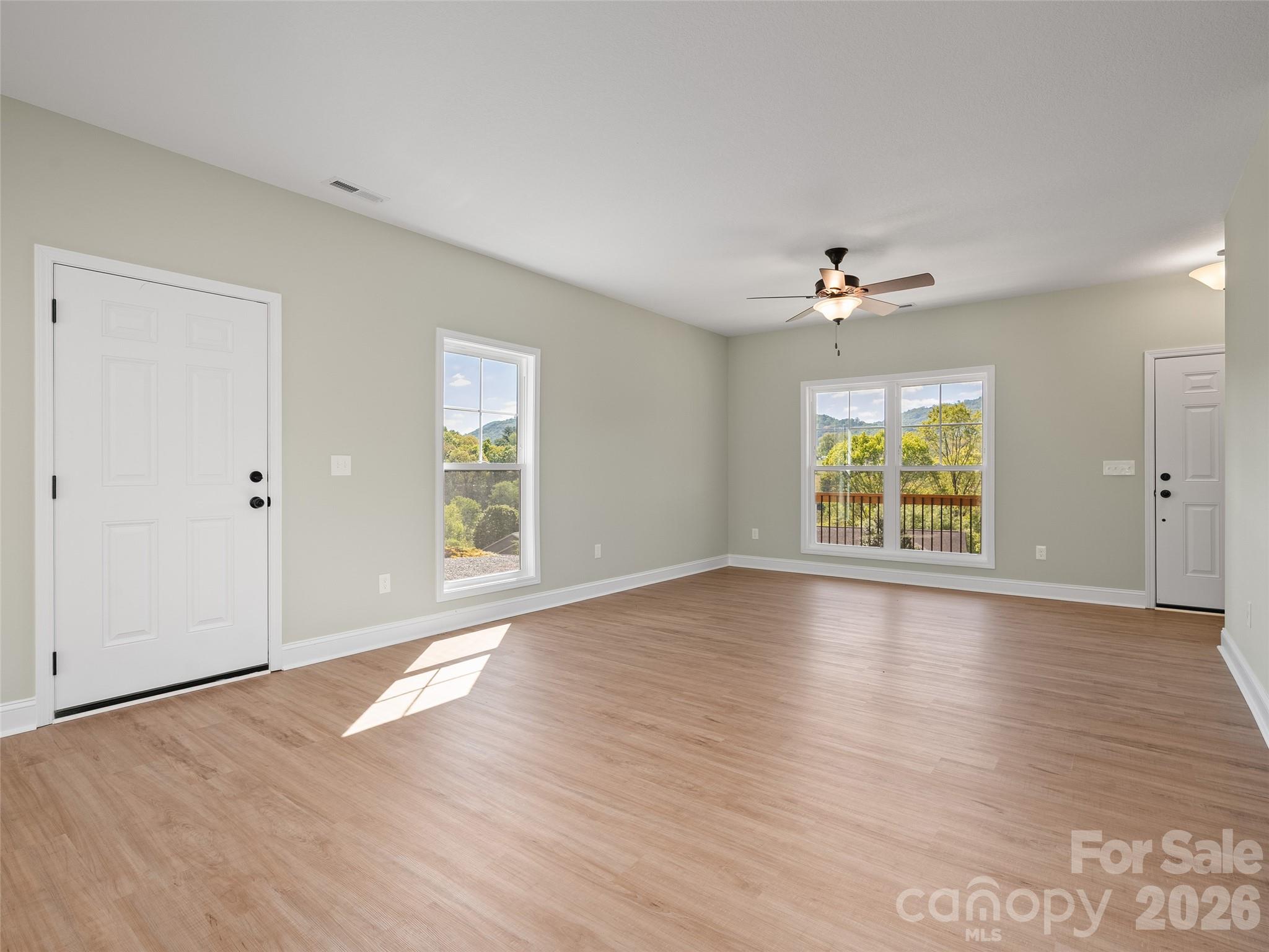 373 Barefoot Ridge Clyde, NC 28721 - Photo 10 of 30 an empty room with window and wooden floor
