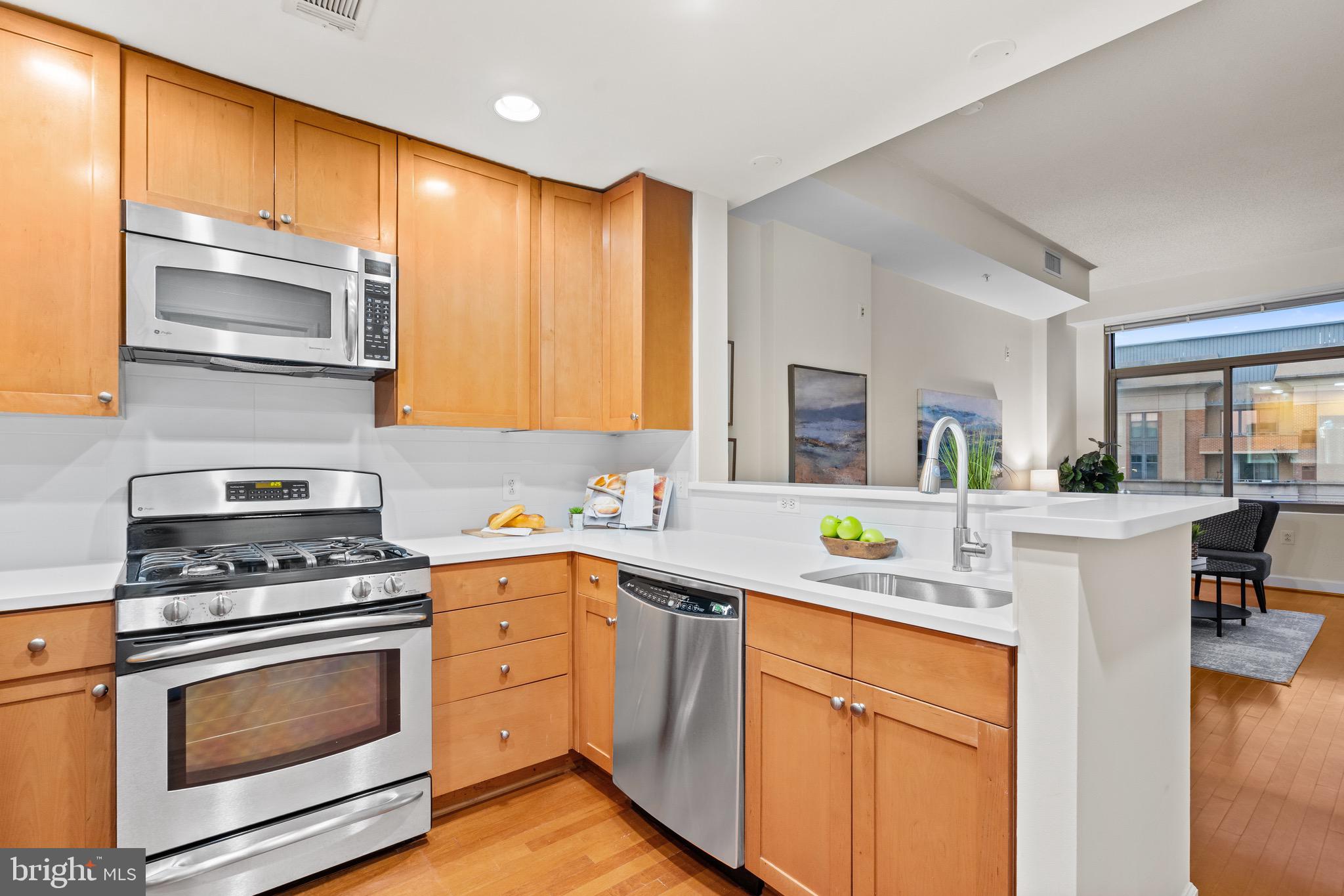 3650 South Glebe Road, Unit 1147 Arlington, VA 22202 - Photo 5 of 51 a kitchen with stainless steel appliances a stove microwave and cabinets