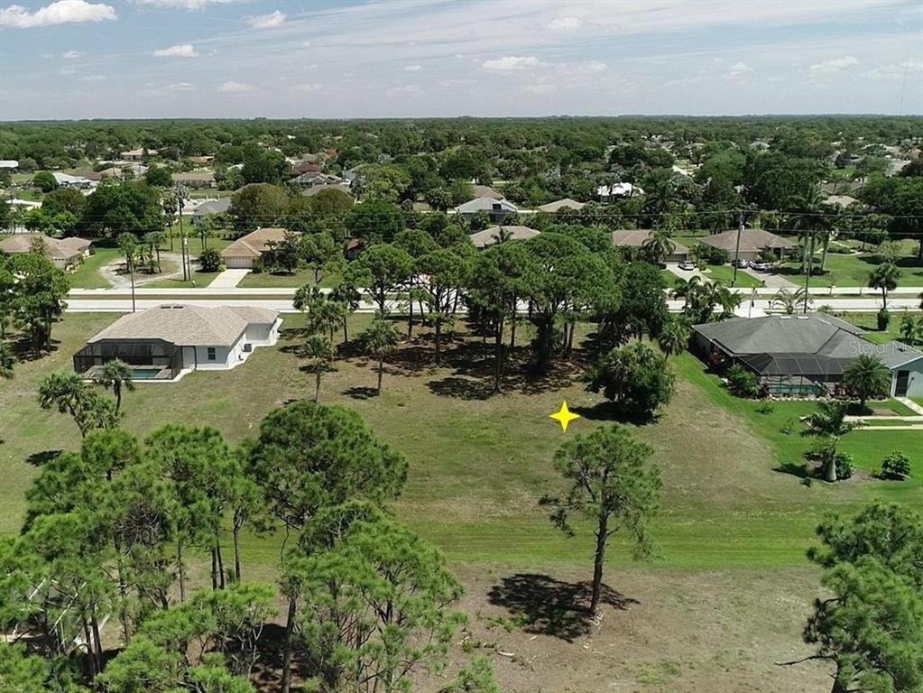 281 Rotonda Boulevard North Rotonda West, FL 33947 - Photo 5 of 5 an aerial view of residential houses with outdoor space and trees