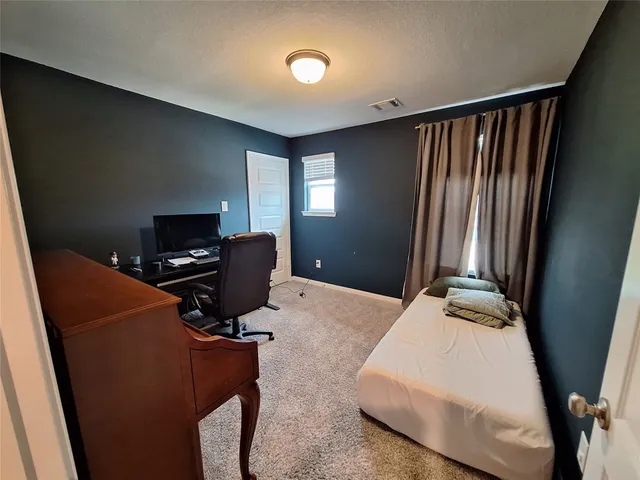 a bedroom with bed and furniture