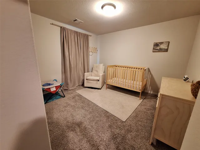 a bedroom with furniture and a window