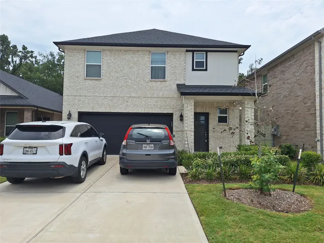 a view of a car parked in front of a house