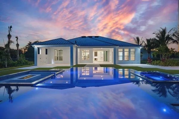 a view of a house with a backyard