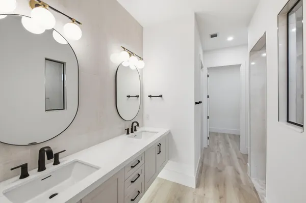 a bathroom with a sink a toilet and a mirror